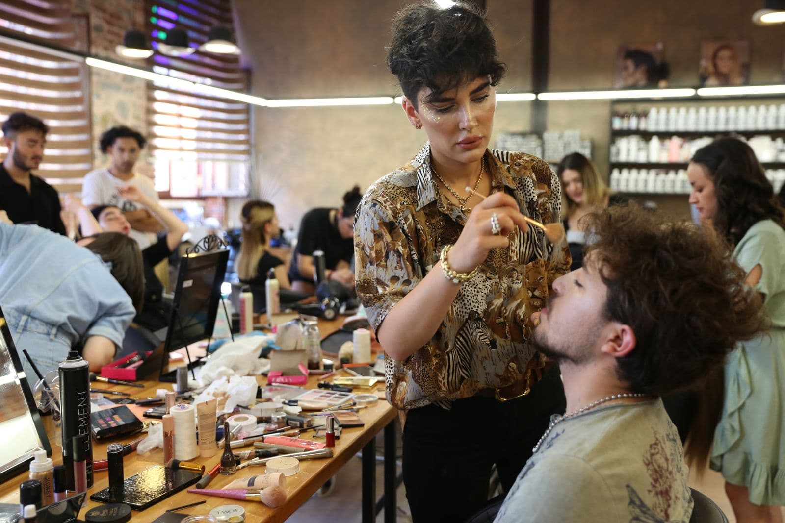 Makeup artist applying cosmetics to a client during a beauty session