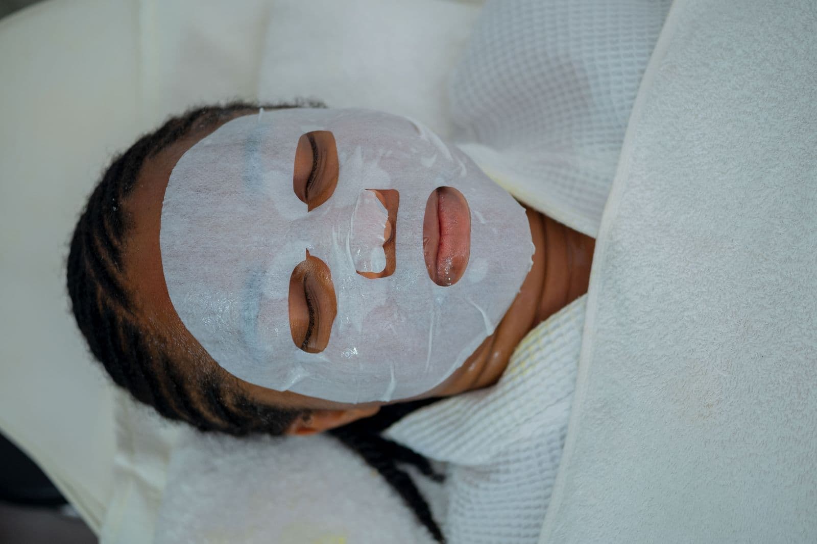 Woman receiving a rejuvenating facial treatment at a beauty spa