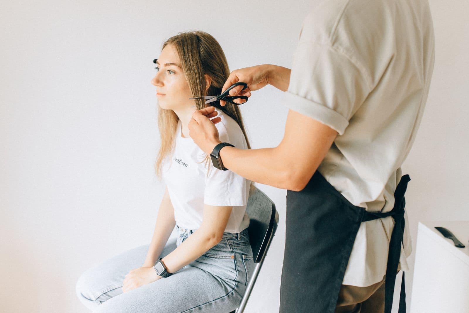 Skilled stylist working on a clients hairstyle with brush and tools