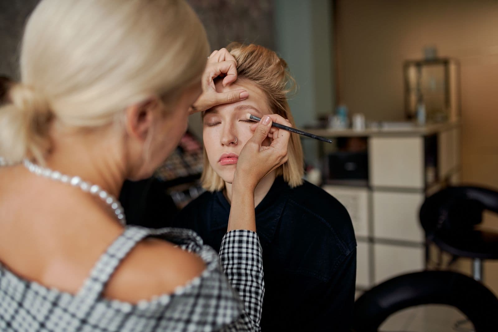 Professional makeup artist working on a clients flawless makeup look