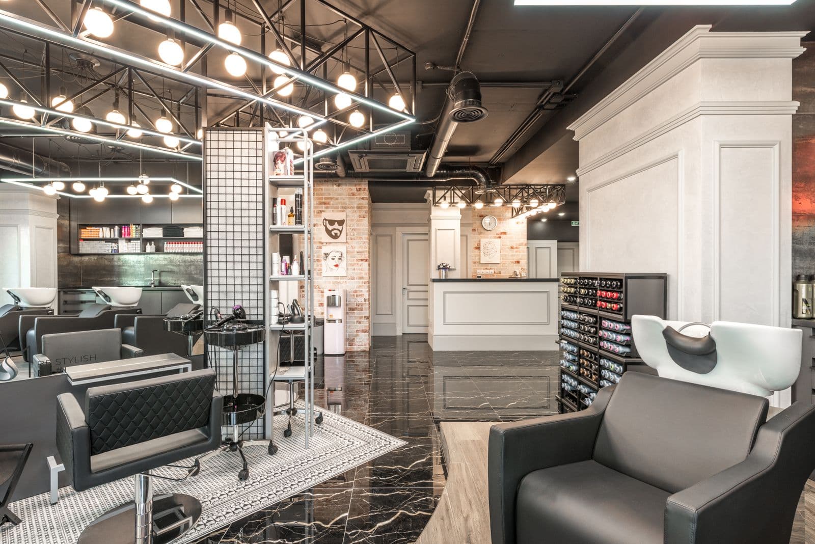 Spacious contemporary hair salon with professional workstations and decor